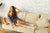 Young woman in loungewear resting on a sofa