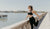 Woman wearing leggins and top stretching on the stone bridge