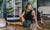 Woman stretching on her terrace dressed in athletic wear
