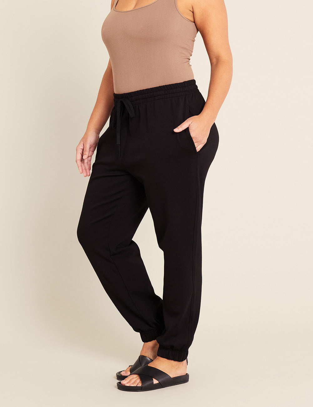 Gender-Neutral-Cuffed-Sweat-Pants-Black-Female-Side.jpg